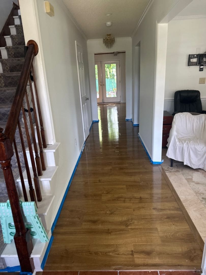 Hallway with new hardwood floors and fresh white trim after an AmeriTribe rebuild